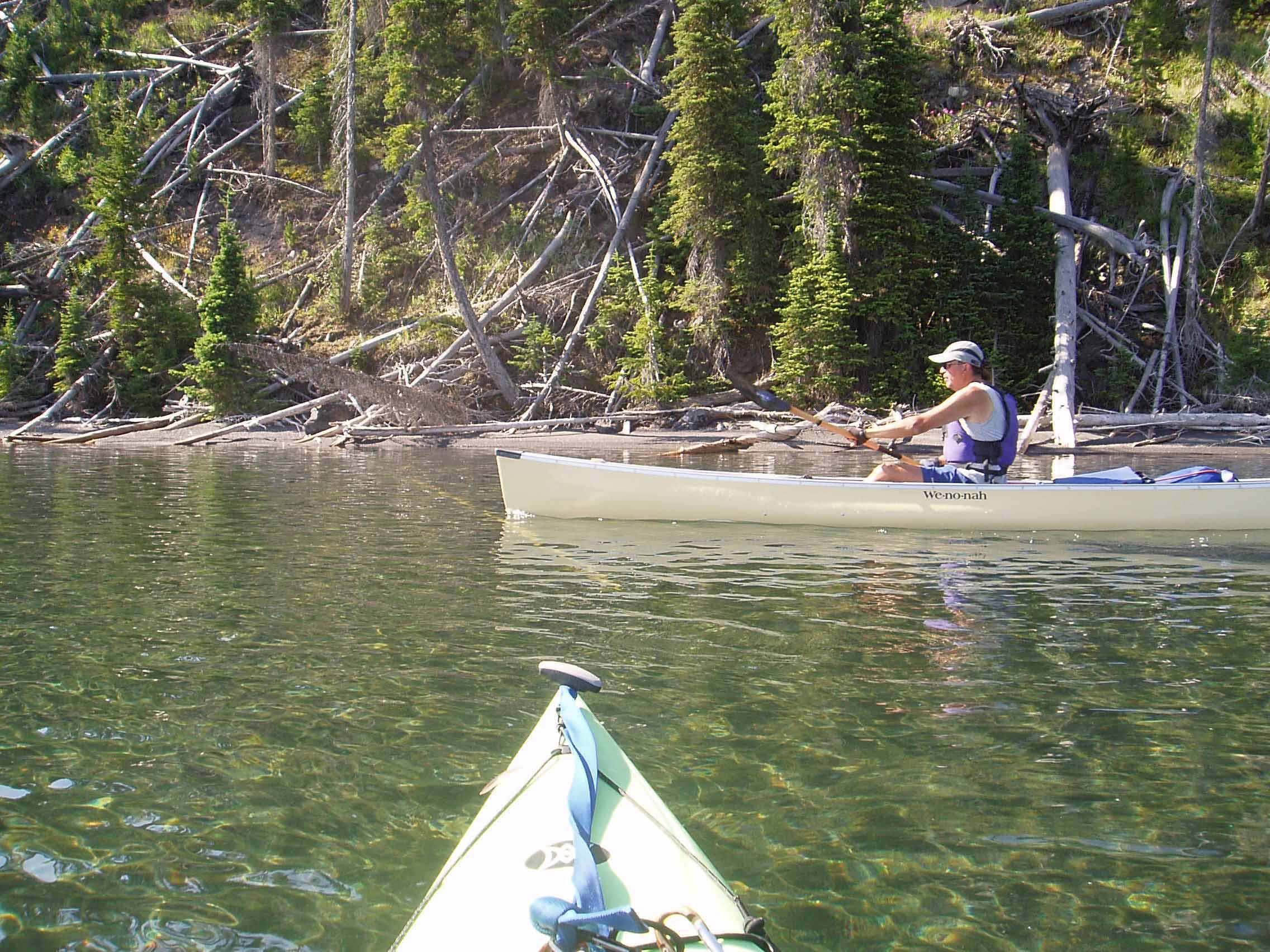 A person riding on the back of a boat in the water

Description automatically generated