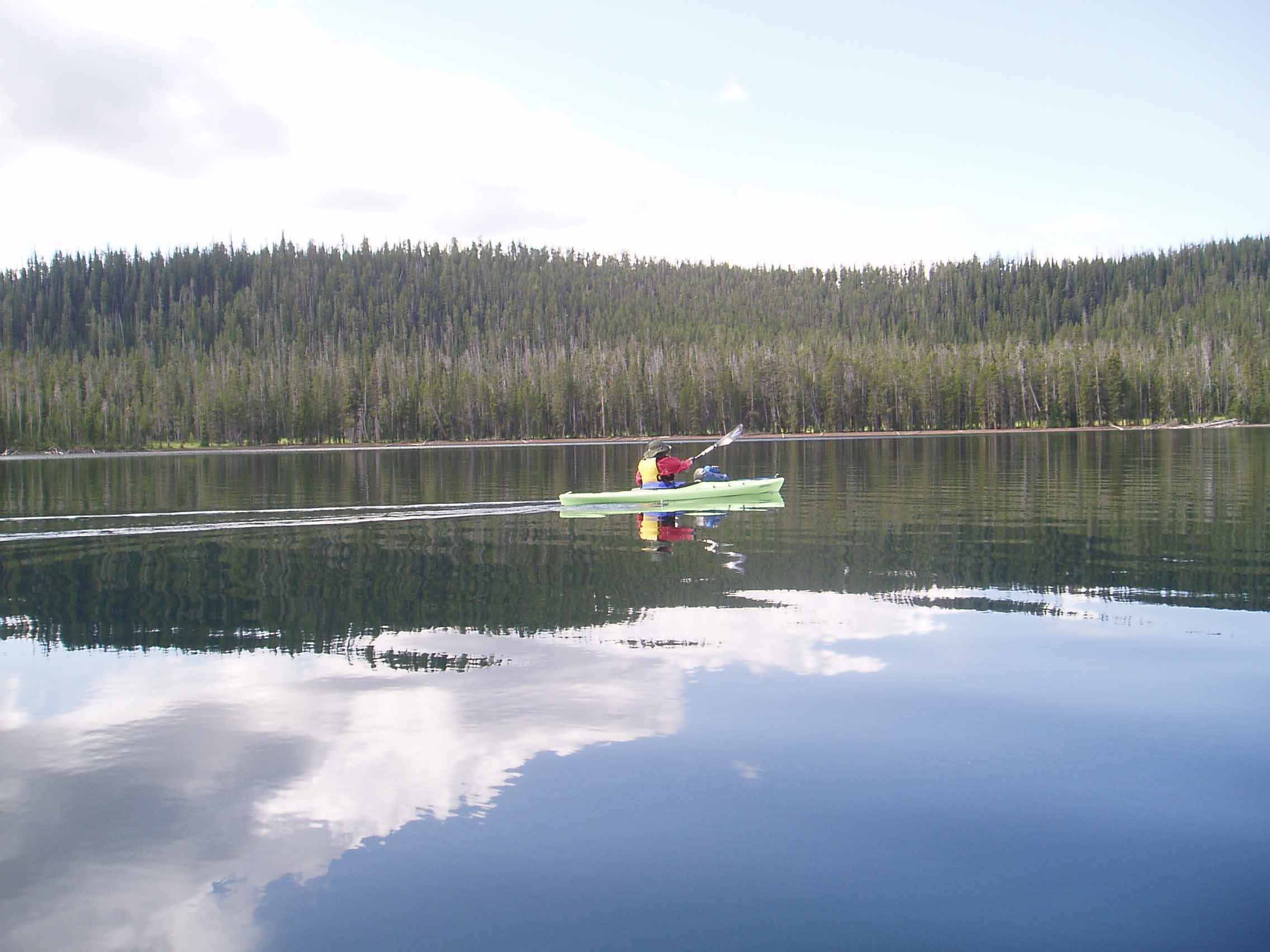 A person standing next to a body of water

Description automatically generated