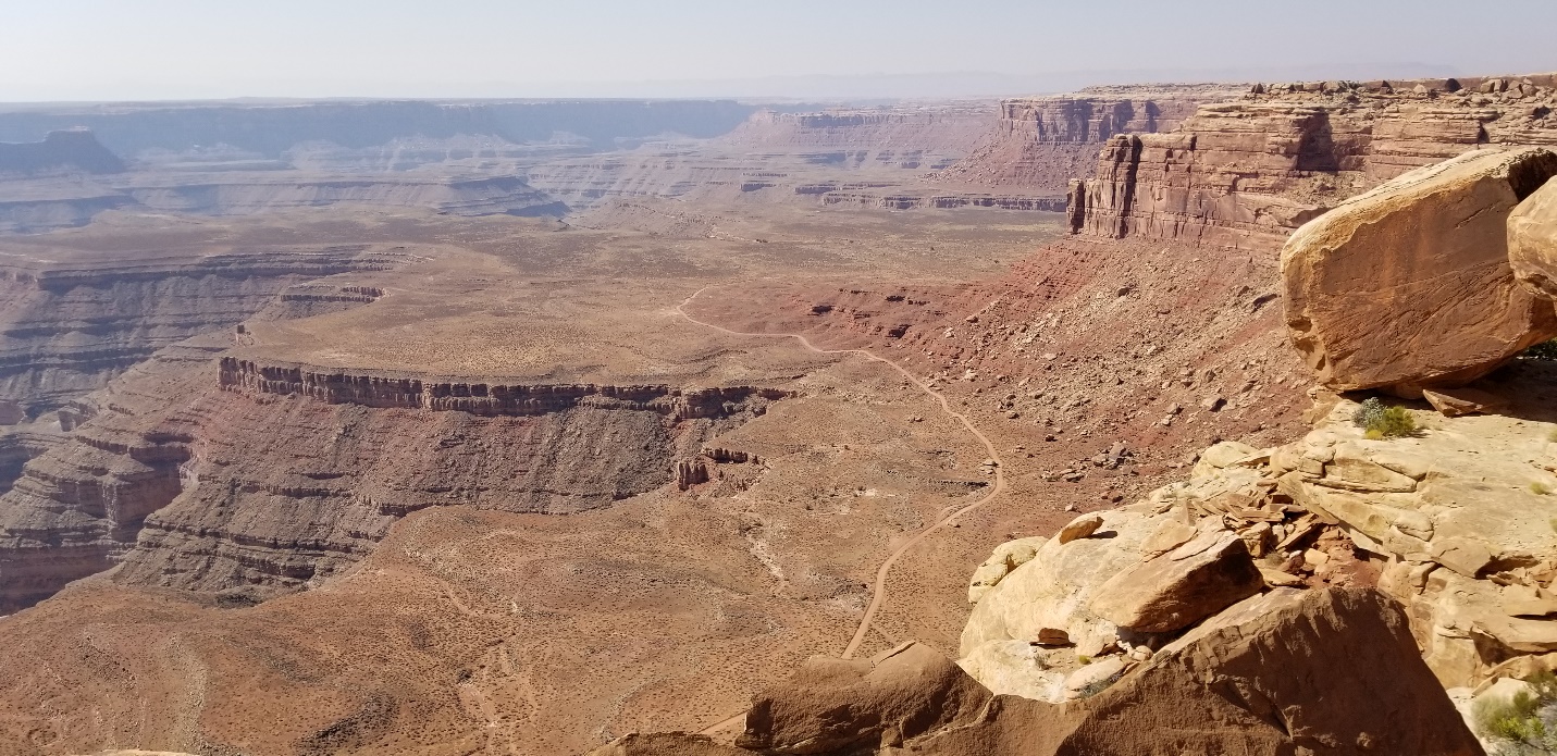 A canyon with a mountain in the background

Description automatically generated