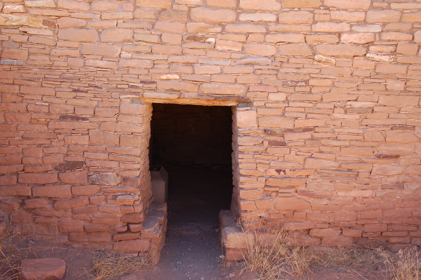 A fire place sitting next to a brick wall

Description automatically generated