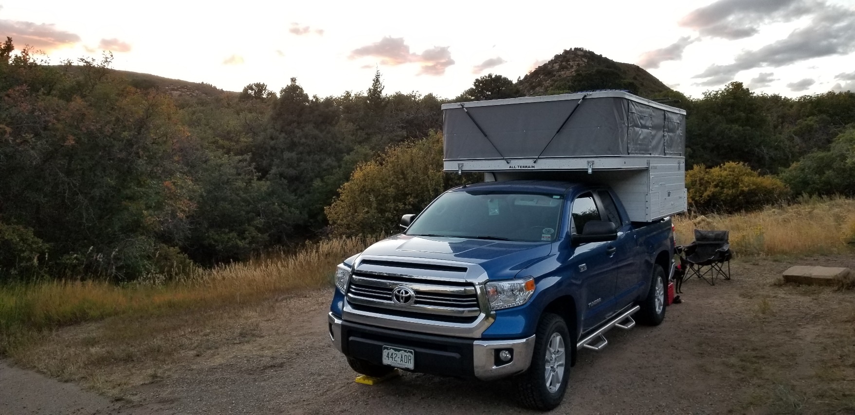 A truck driving down a dirt road

Description automatically generated