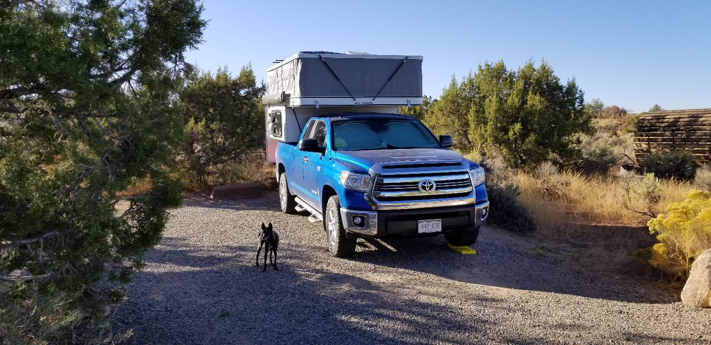 A truck driving down a dirt road

Description automatically generated