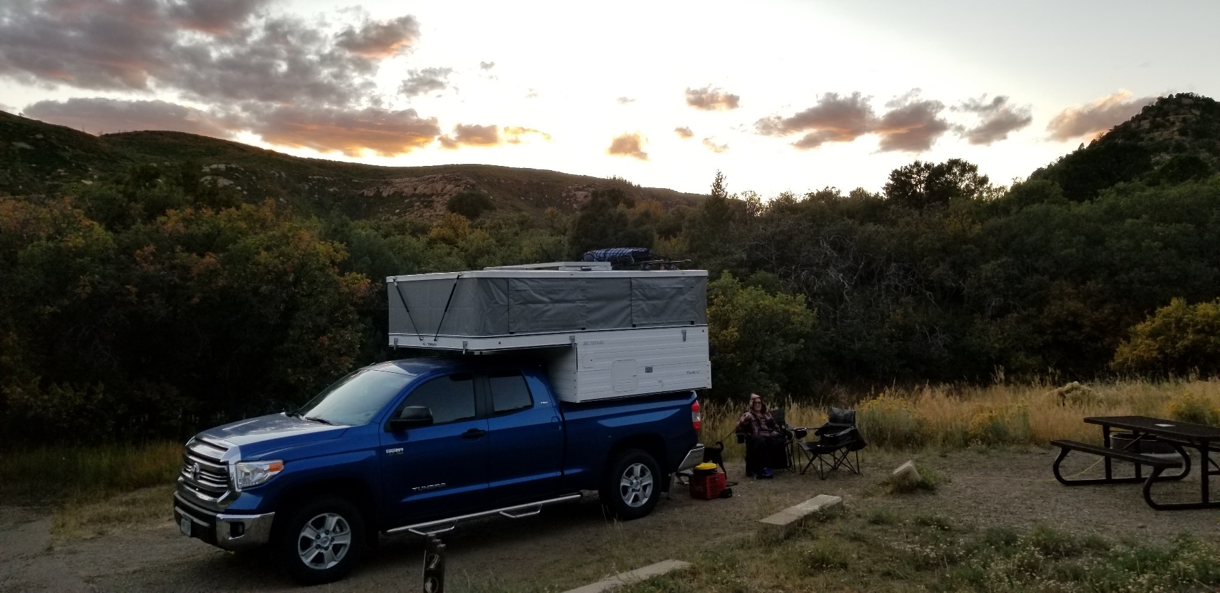 A truck driving down a dirt road

Description automatically generated